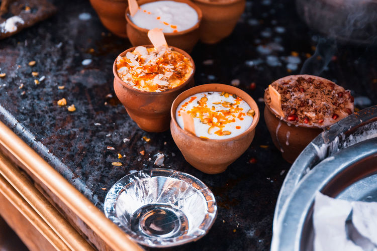 Close-up of lassi served in clay cups