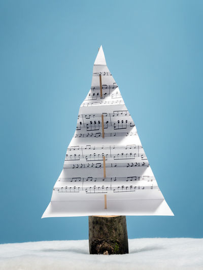 Paper in triangle shape against blue background