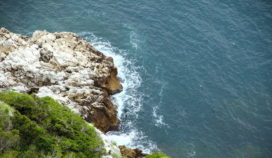 High angle view of rocks on sea