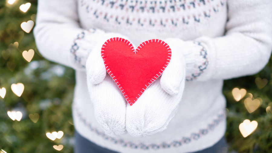 Close-up of person holding heart shape in winter