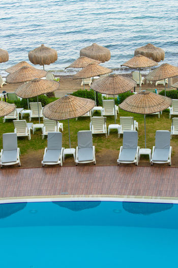 High angle view of lounge chairs and table at beach