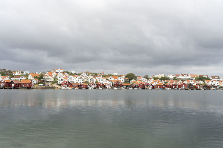 Old idyllic houses by sea against sky in sweden