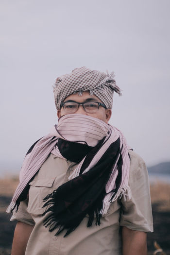 Portrait of man wearing mask against sky