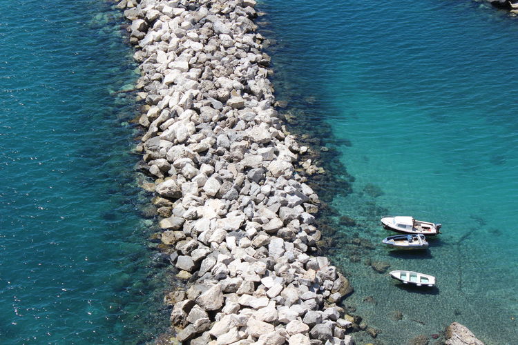 High angle view of rocks at sea shore