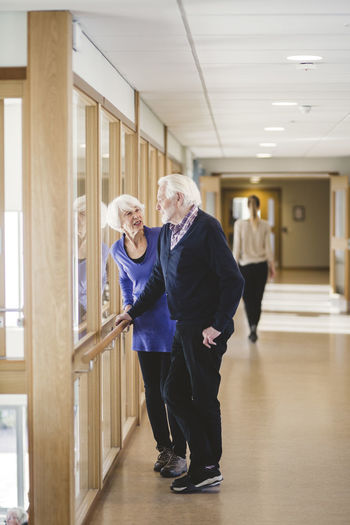 Man and woman walking in corridor of building
