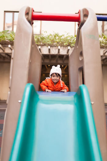 Full length of boy on slide at playground