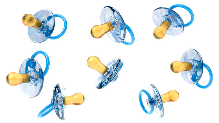 High angle view of bottles on glass against white background