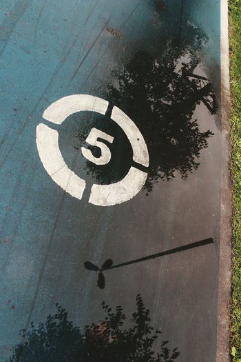 High angle view of road sign on street