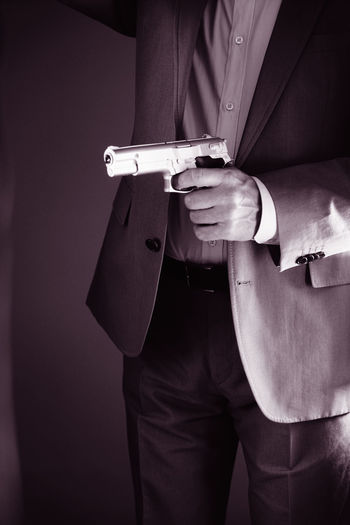 Midsection of man using mobile phone