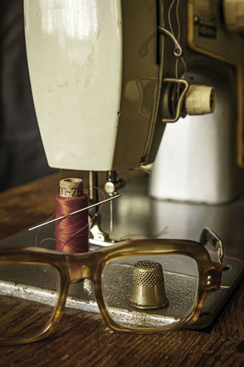 View of the thimble through glasses on the sewing machine table