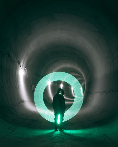 Futuristic cyberpunk man in a tunnel with neon light rim
