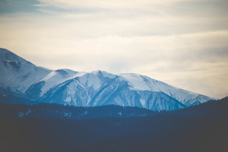 Scenic view of snowcapped mountains against sky