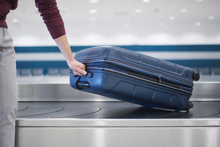 Midsection of woman holding suitcase