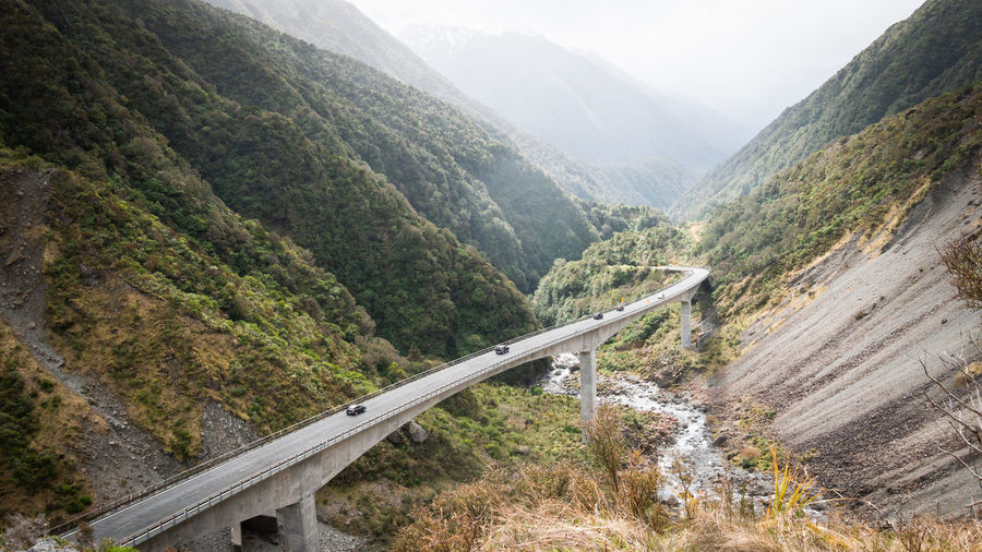 Highway winding through green mountain valley. otira viaduct. arthurs pass national park,new zealand