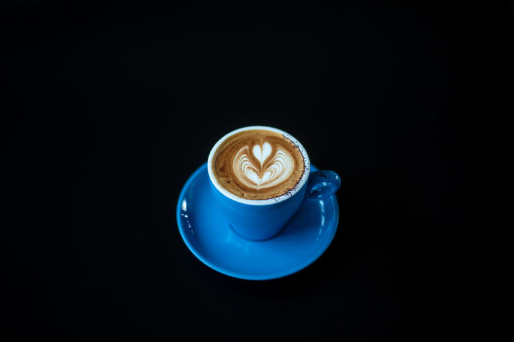 Coffee cup against black background