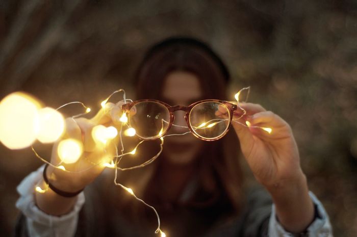 Close-up of woman holding eyeglasses