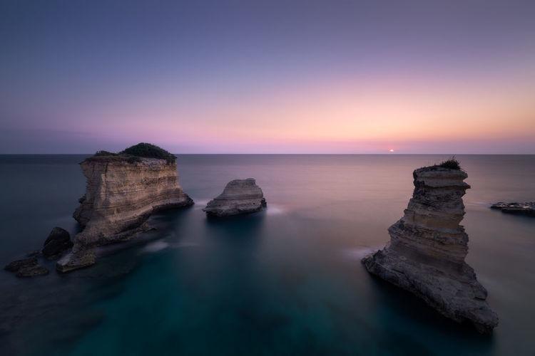 Long exposure sunrise dawn with a seascape. lovely sea lecce salento with su  coming up from horizon