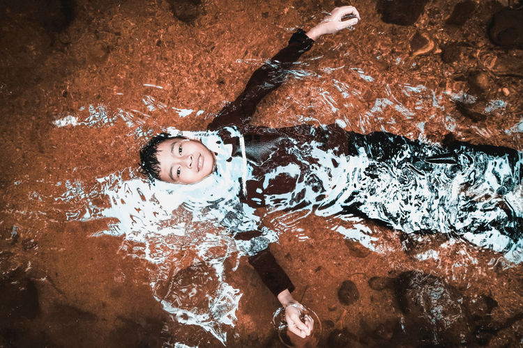 High angle portrait of boy in river