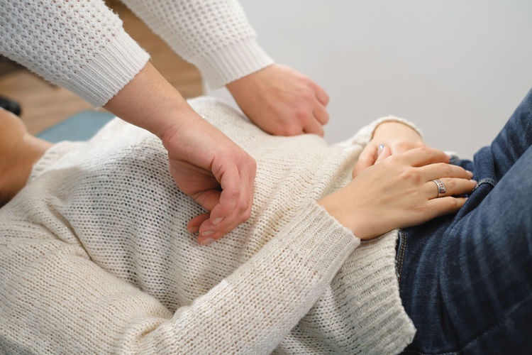 Midsection of woman holding hands