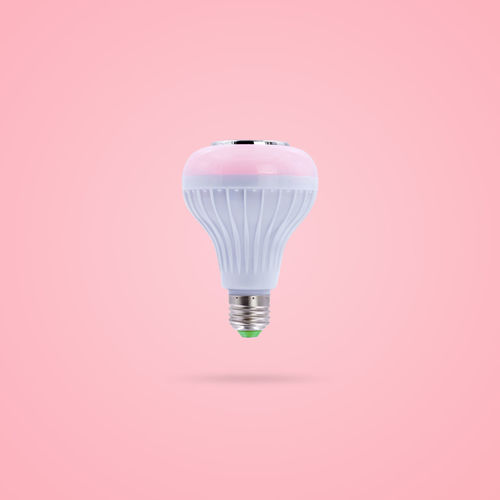 Close-up of light bulb against pink background