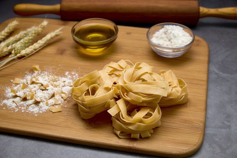 Italian pasta on a board with a wood kneader. food concept