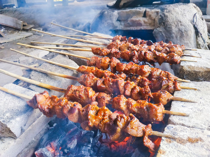 High angle view of meat on barbecue grill
