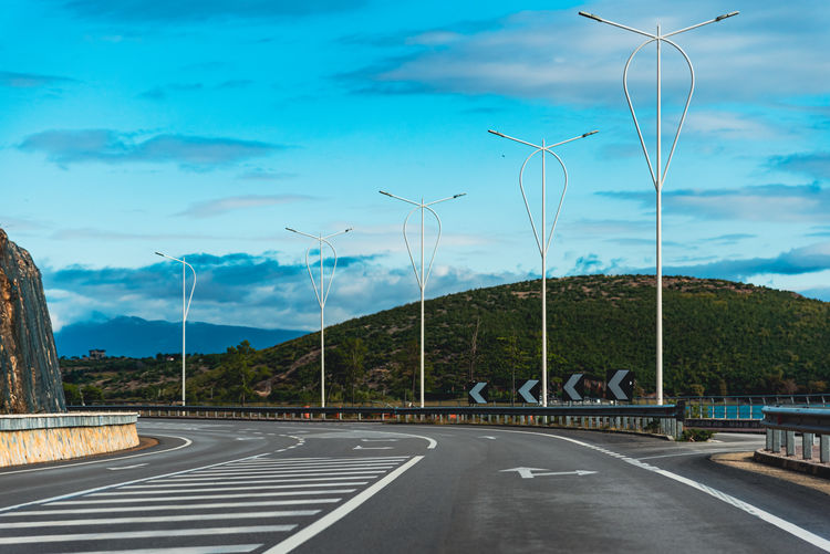 Road by mountain against sky