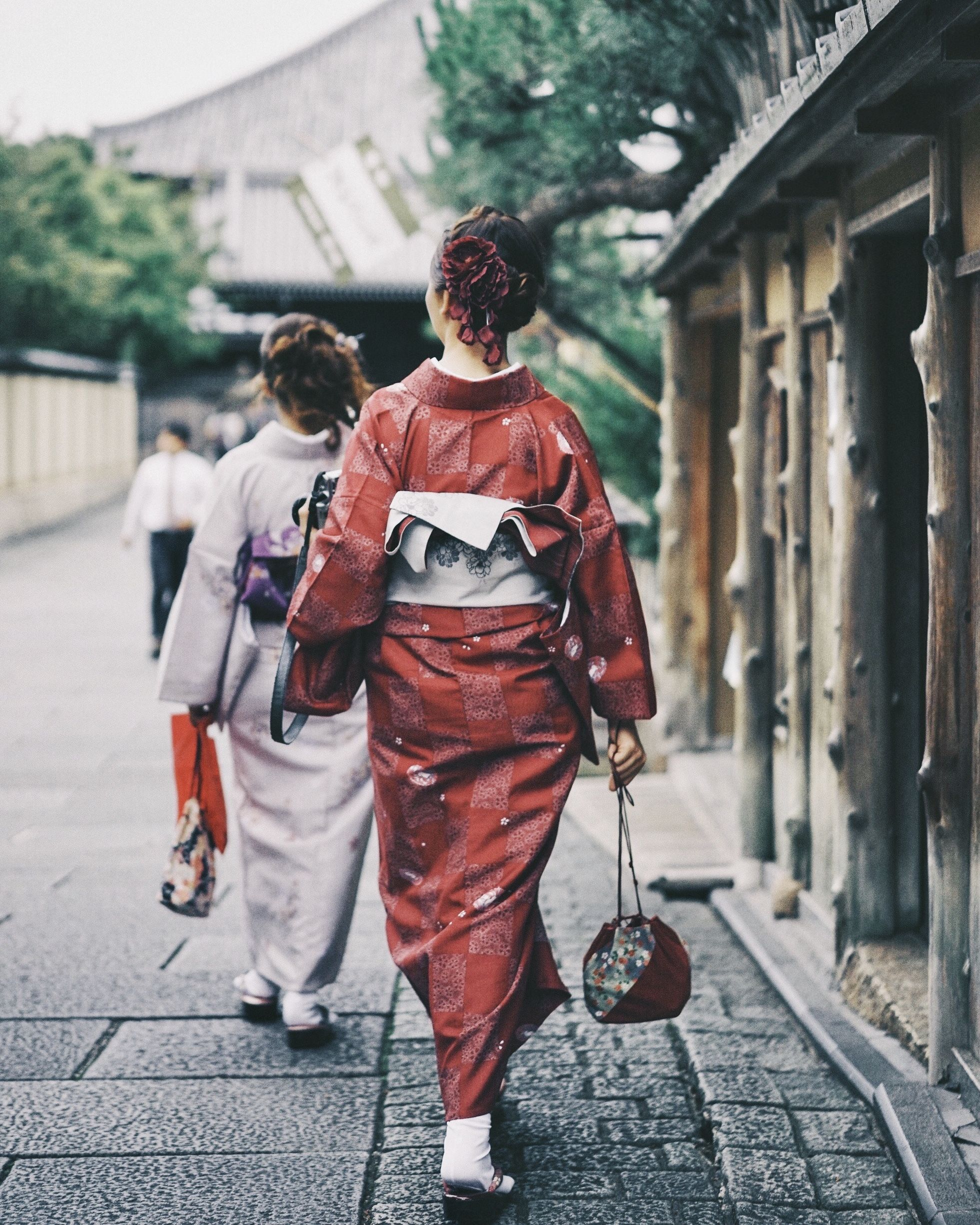 architecture, street, adult, men, road, city, two people, full length, rear view, walking, spring, person, clothing, red, building exterior, built structure, lifestyles, footpath, togetherness, women, outdoors, day, footwear, traditional clothing