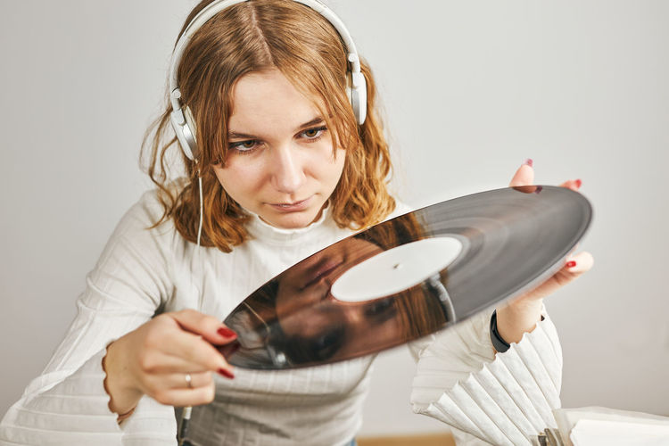 Portrait of young woman playing violin at home