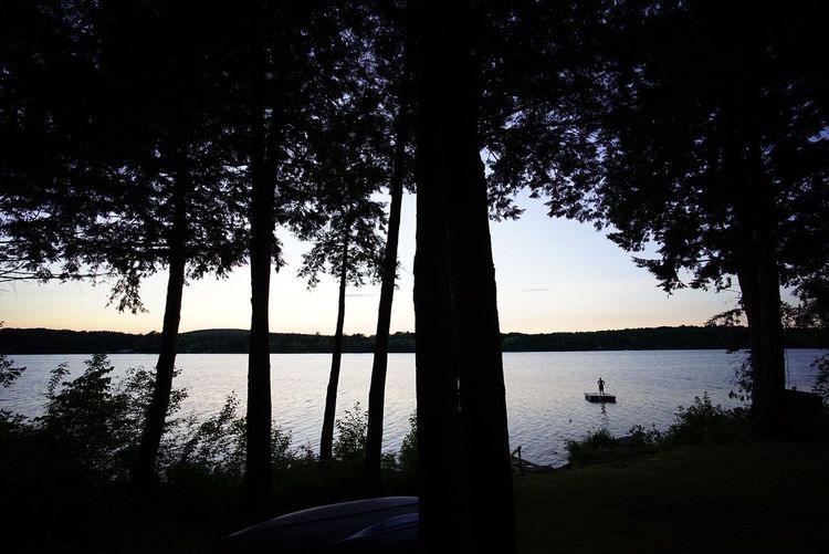 Scenic view of lake against sky at sunset
