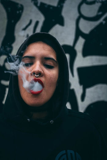 Close-up of woman exhaling smoke
