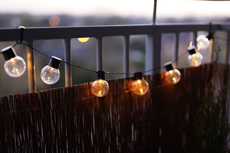 View of illuminated light bulbs hanging