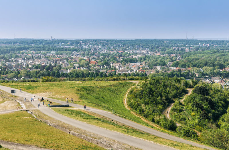 High angle view of road amidst field against sky