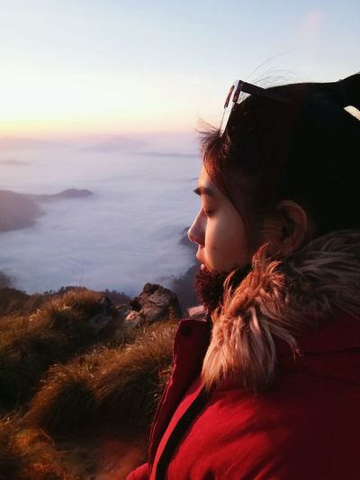 Side view of thoughtful young woman with eyes closed on mountain