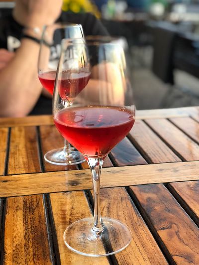 Close-up of red wineglass on table at outdoor restaurant