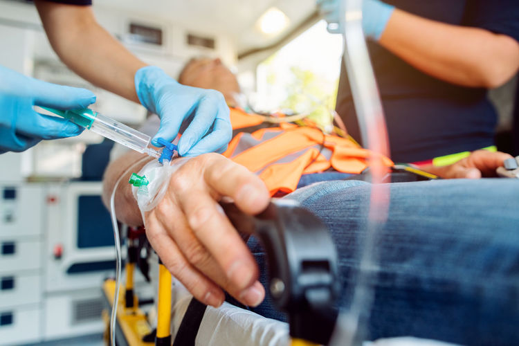 Close-up of hands working in ambulance