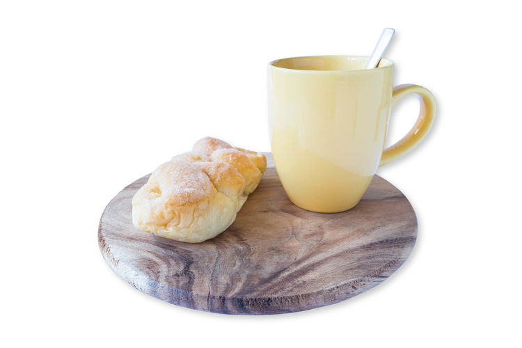 Close-up of bread and coffee on white background