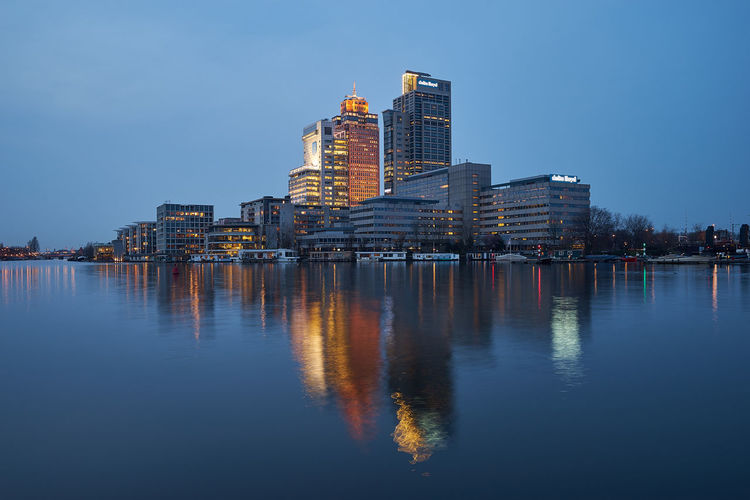Modern buildings with water reflection in the evening