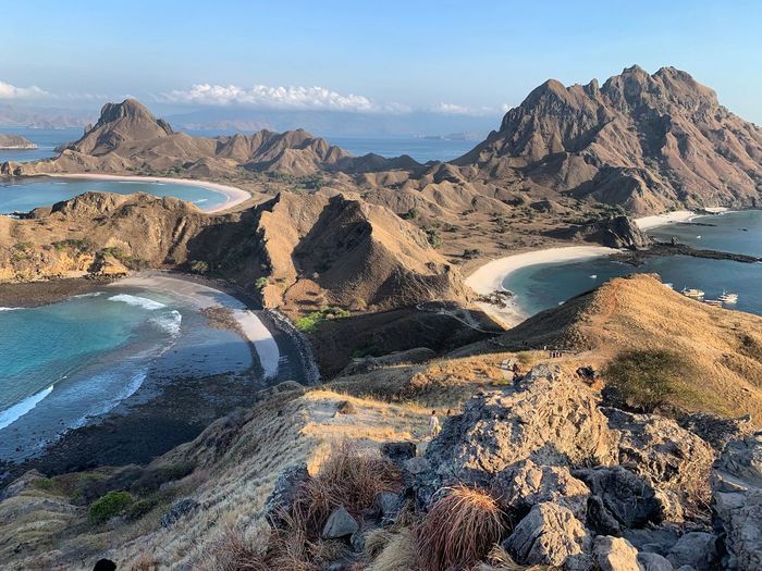 Scenic view of sea and mountains against sky at padar island komodo 