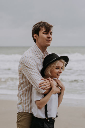Portrait of couple standing on beach