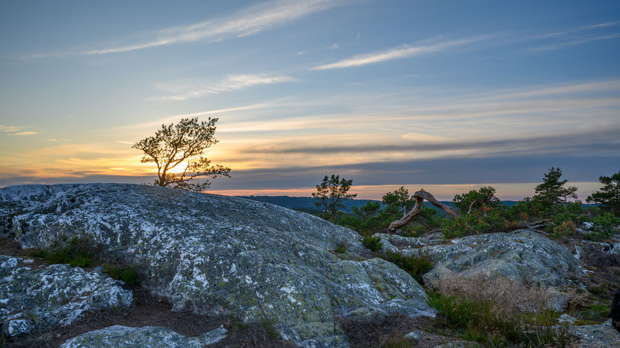 Scenic view of rocks against sky during sunset