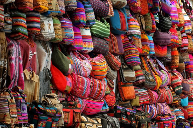 Colorful bags displayed at market stall