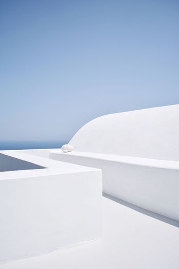 White colored footpath against clear blue sky