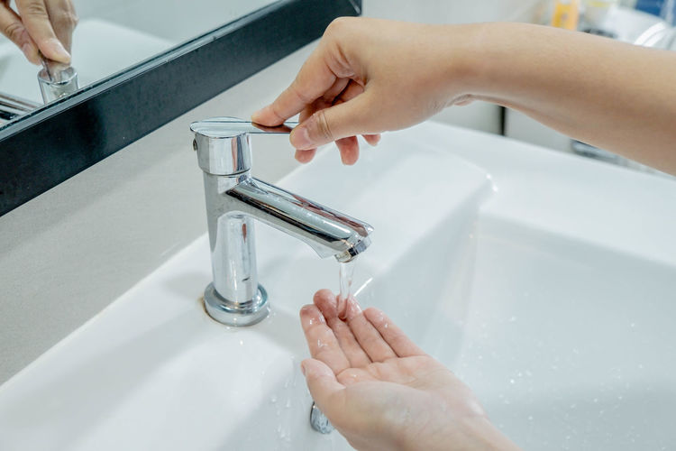 Cropped image of hand holding bathroom