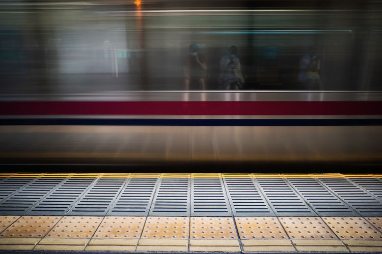 Blurred motion of train at railroad station