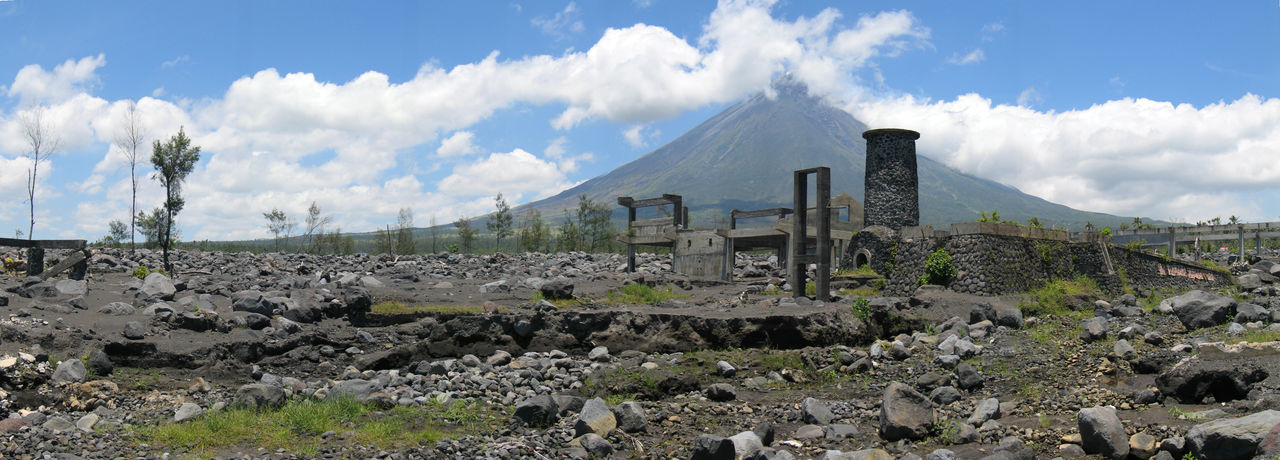 Panoramic shot of old ruins with mayon volcano in background