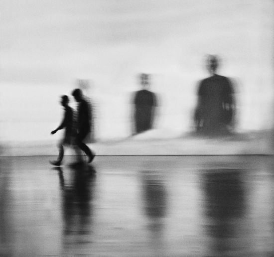 Blurred motion of people walking on street in city