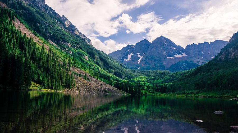 Scenic view of lake and mountains against sky