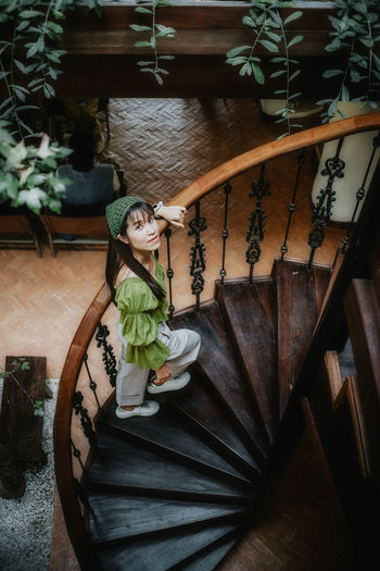 High angle view of woman potted plant on staircase