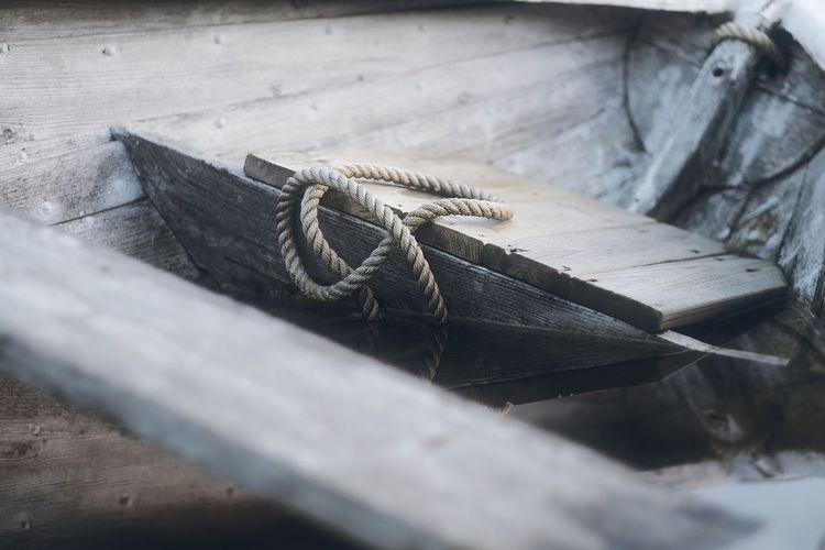 High angle view of rope tied on wooden plank